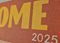 Close-up of a book cover with 'ROME 2025' text on a brown background