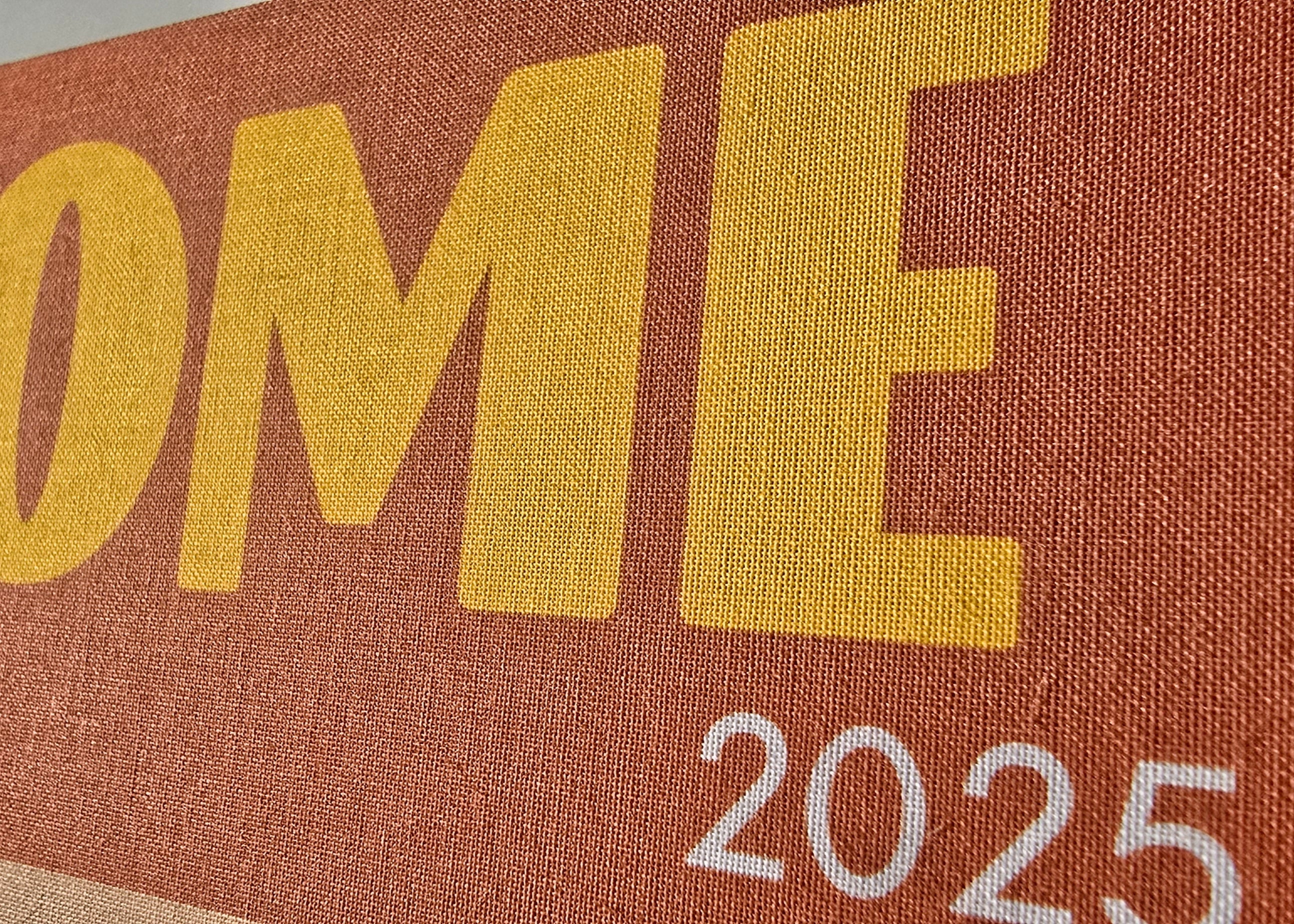 Close-up of a book cover with 'ROME 2025' text on a brown background