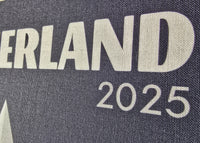 Text 'SWITZERLAND 2025' on a textured surface with a mountain graphic.